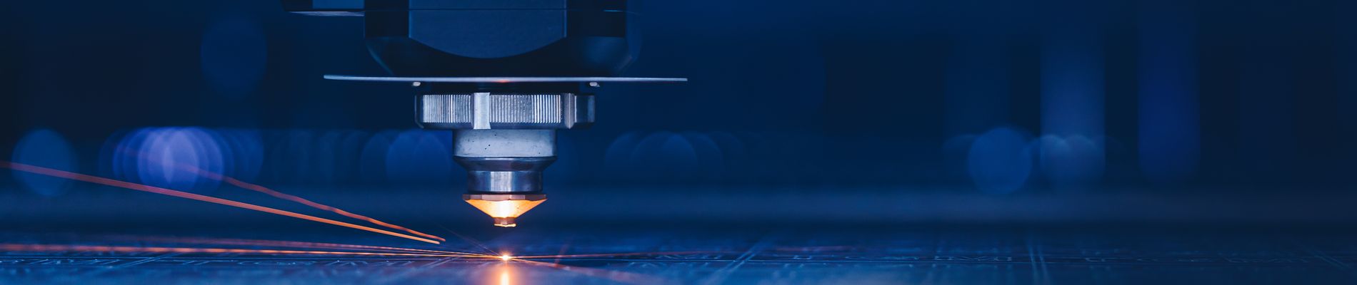 Laser CNC cut of metal with light spark. Blue color background banner, technology modern industrial